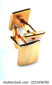 Gold Cuff Links On White Background