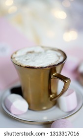  Gold Cup Of Coffee With White, Pink Marshmellow. Light Bokeh                              