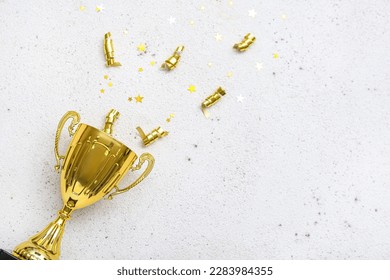 Gold cup with serpentine and stars on light background