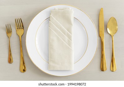 Gold cutlery table setting flatlay