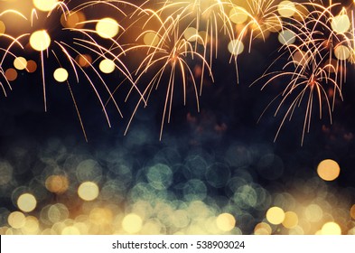 Gold and dark blue Fireworks and bokeh in New Year eve and copy space. Abstract background holiday.