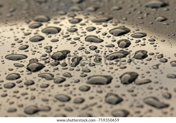 Gold Drops of\
Rain or Water Drop on the Hood of the Car. Rain Drops on the\
Surface of the Car or on the Iron Surface Flow Down. Abstract\
Background and Water Texture for\
Design.