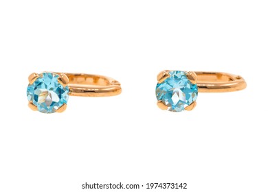 Gold earrings with blue topaz. Jewelry isolated on white background - Shutterstock ID 1974373142