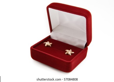 Gold  Earrings In A Jewelry Box On White Background