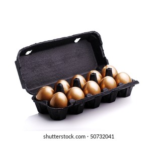 Gold eggs in a black carton on white background - Powered by Shutterstock