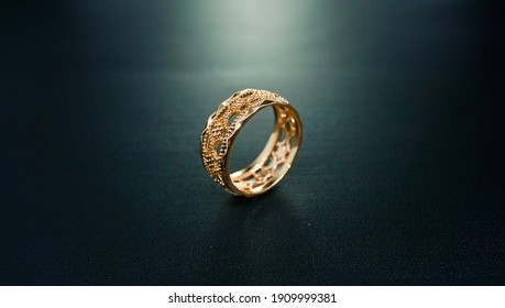 Gold Engagement Ring Accompanied By A Simple And Elegant Motif