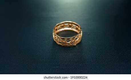 Gold Engagement Ring Accompanied By A Simple And Elegant Motif