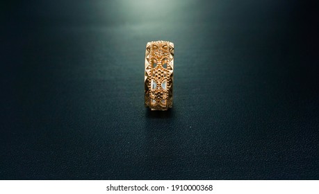 Gold Engagement Ring Accompanied By A Simple And Elegant Motif