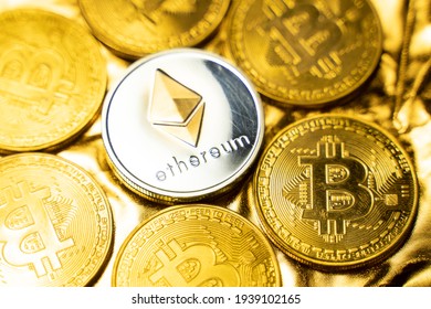 Gold ethereum coins among bitcoins on a golden background. Trading on the cryptocurrency exchange. Cryptocurrency Stock Market Concept. Virtual money concept. Mining or blockchain technology.