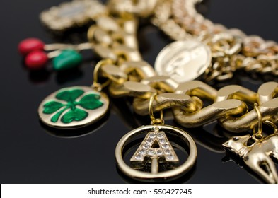 Gold Fashion Lucky Charm Bracelet On Black Isolated Background