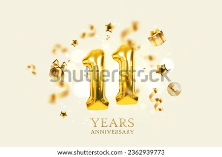Gold festive balloons 11 years anniversary with golden confetti, presents, mirror ball and stars fly on a beige background with bokeh lights and sparks. Birthday luxury eleven card, a creative idea