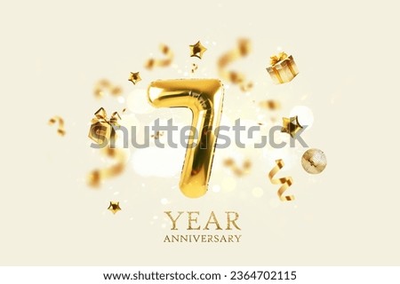 Gold festive balloons 7 year anniversary with golden confetti, presents, mirror ball and stars fly on a beige background with bokeh lights and sparks. Birthday luxury seven card, a creative idea