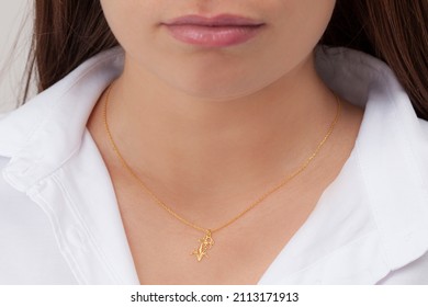 Gold Flower Necklace On Neck Of Attractive White Dress Girl. Personalized Necklace Image. Jewelry Photo For E Commerce, Online Sale, Social Media.