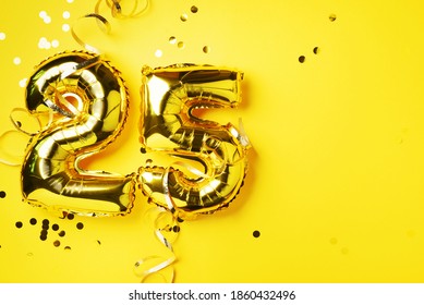 Gold foil balloon number, digit twenty-five. Birthday greeting card with inscription 25. Anniversary celebration event. Banner. Golden numeral, yellow background. Numerical digit, bright shiny glitter