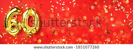 Gold foil balloon number, digit sixty. Birthday greeting card with inscription 60. Anniversary celebration event. Banner. Golden numeral, red background. Numerical digit, light bokeh, glitter