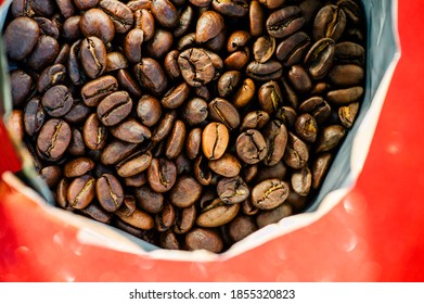 Gold Foil Coffee Bean Bag Isolated On Red Background. Coffee, Cheerfulness, Aroma