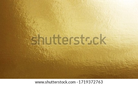 Gold foil gradient texture background with uneven surface     