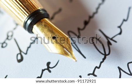 Gold fountain pen on hand written letter