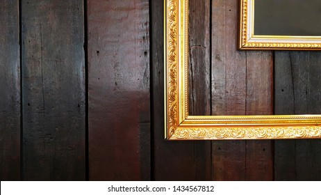 Gold Fram On The Wood Wall.