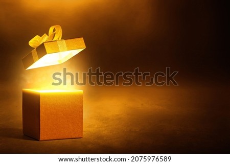 Gold gift box on dark background