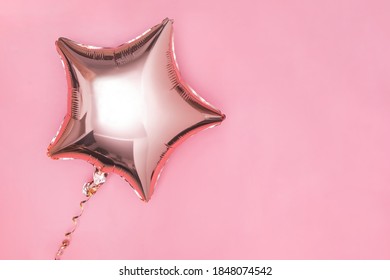 Gold Glitter Foil Star Shaped Balloon Isolated On Pink Background