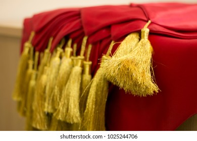 Gold Graduation Cords And Red Scarfs Graduate Accessories Background With Space For Text