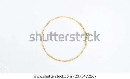 Gold guitar strings isolated on white background.
