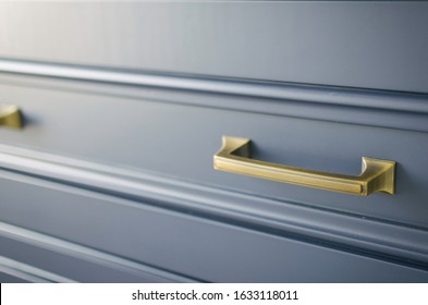 gold hardware on blue cabinets - Shutterstock ID 1633118011