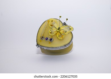 Gold Heart Shaped Gift Box With Butterfly Ornament On White Background.