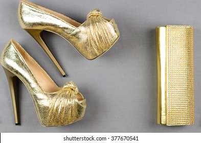 gold heels and clutch bag