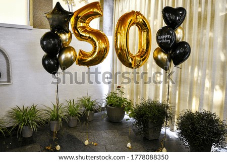 Gold inflatable balls in the form of a figure 50, Birthday anniversary party. Gold 50th Birthday Party Balloons. Photoshooting zone