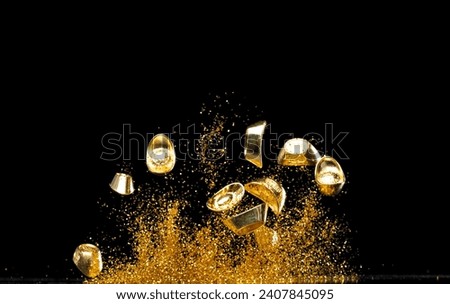 Gold Ingot Chinese Money bar token fly with dust particle in air. Chinese new year Yuanbao gold ingots floating to golden money sand particle. Language is wealthy prosperity. Black background isolated