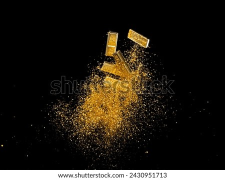Gold Ingot Chinese Money bar token fly with dust particle in air. Chinese new year Yuanbao gold bar floating to golden money sand particle. Language is wealthy prosperity. Black background isolated