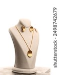 Gold jewel on stand on white background
