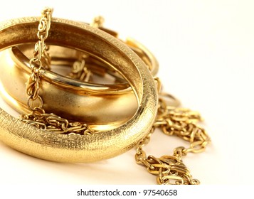 Gold Jewelry, Bracelets And Chains On A White Background