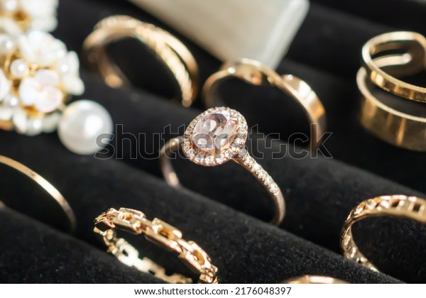 Gold jewelry diamond rings show in luxury retail\
store display showcase