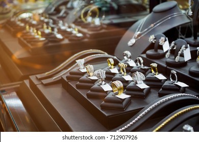 Gold jewelry diamond shop with rings and necklaces luxury retail store window display showcase  - Shutterstock ID 712907926