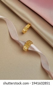 Gold jewelry on a gold background. Gifts for Valentine's Day Joyful girlfriends, women and wives pure pink and gold background