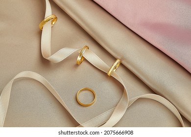 Gold jewelry on a gold background. Gifts for Valentine's Day Joyful girlfriends, women and wives pure pink and gold background