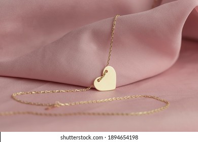 Gold jewelry on a pink background. Gift for Valentine's Day. Pleasure girlfriends, women, wives. Preparing for Valentine's Day. Pure pink background, fabric. earrings, ring, diamonds, chain - Shutterstock ID 1894654198