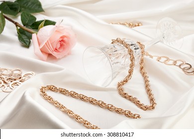 Gold Jewelry, Pink Rose, Wine Glass On Silk Fabric