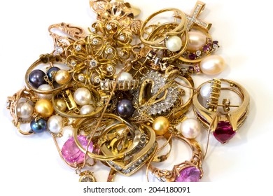 gold jewelry scrap on a white background, pawnshop concept, jewelry inspection and verification, close-up