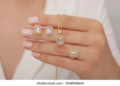 Gold Jewelry Set With Baguette Stone On Well-groomed Hand