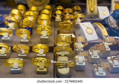 Gold Jewelry At Showcase Of Jewelry Shop. Gold Items In Shop Windows