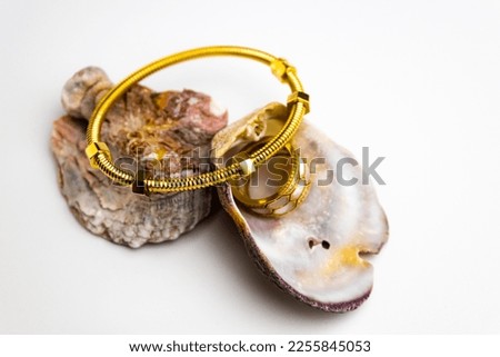gold jewelry with silver. High quality photo, Panoramic shot of golden bracelets and ring on white background with copy space