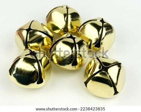 Gold jingle bells on a white background isolated