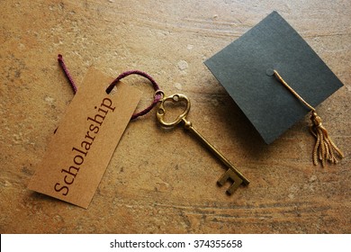Gold key with Scholarship tag, with graduation cap                                - Shutterstock ID 374355658
