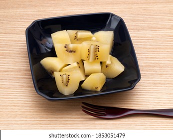 Gold Kiwifruit Cut And Served On A Plate.