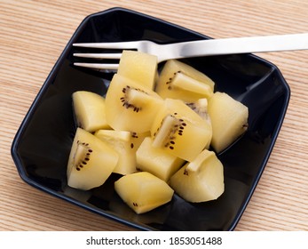 Gold Kiwifruit Cut And Served On A Plate.