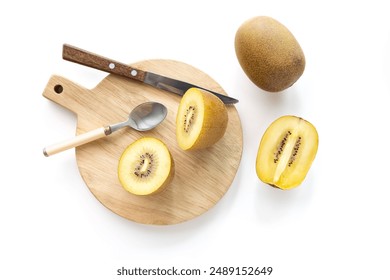 Gold Kiwis cut on a wooden cutting board. Fruit knife, white background
 - Powered by Shutterstock